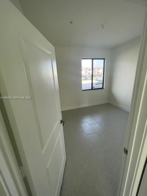8167 Northwest 41st Street, Unit E111 Doral, FL 33166 - Photo 8 of 14 an empty room with a window
