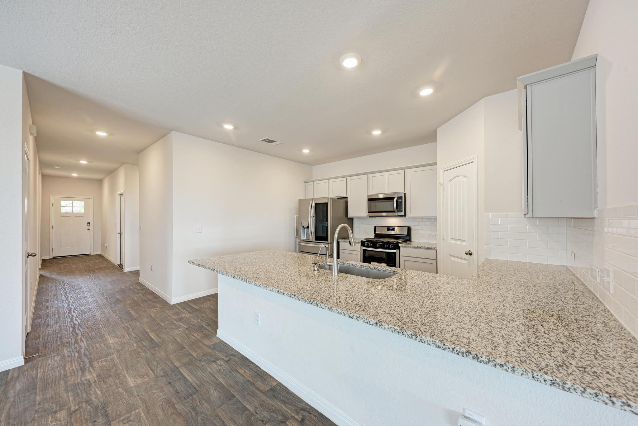 208 Abby Road Georgetown, TX 78626 - Photo 15 of 40 a view of kitchen with sink refrigerator and microwave