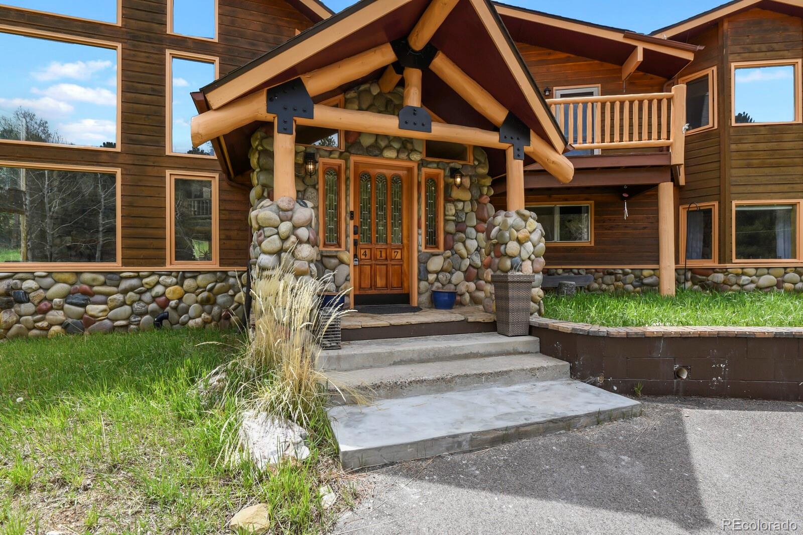 417 Witter Gulch Road Evergreen, CO 80439 - Photo 3 of 50 front view of house with a yard