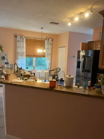 a kitchen with sink and refrigerator