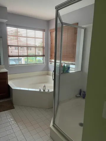a bath tub sitting in a bathroom next to a window