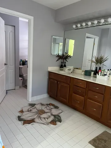 a spacious bathroom with a double vanity sink and a mirror