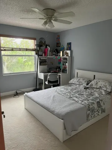 a bed sitting in a bedroom next to a window