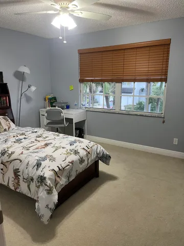 a bed sitting in a bedroom next to a window