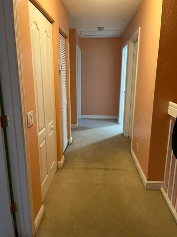 a view of hallway with shower and a window