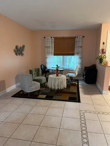 a living room with furniture and large windows