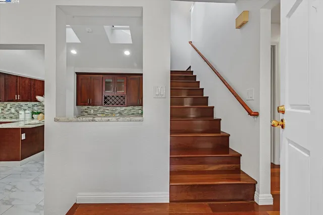 a view of entryway and hall with wooden floor