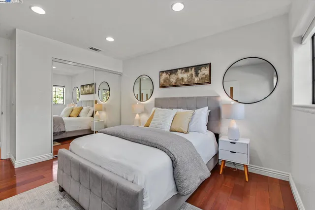 a bedroom with bed and a chandelier