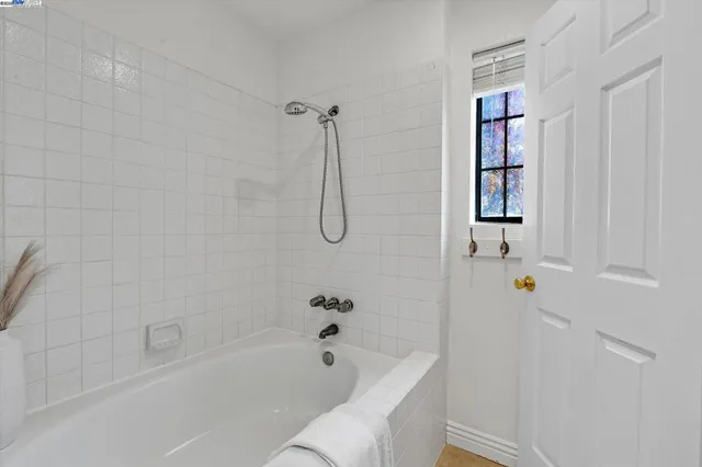 a bathroom with a bathtub a shower and a toilet