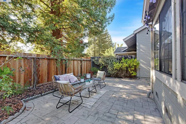 a backyard of a house with table and chairs