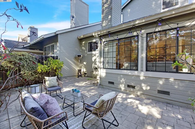 a view of a chair and tables in the patio