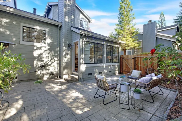 a view of a patio with table and chairs and potted plants