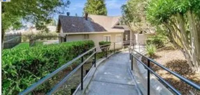 a view of a house with a yard and a wooden deck