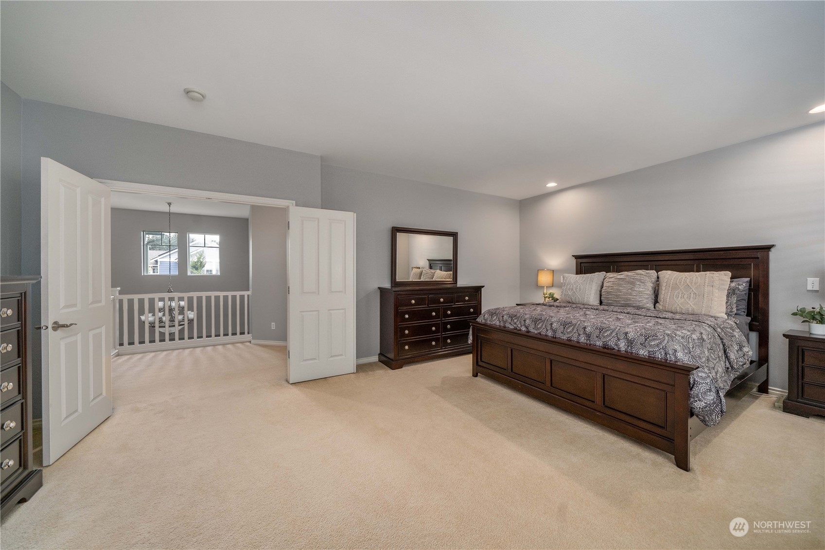 27730 Maple Ridge Way Southeast Maple Valley, WA 98038 - Photo 22 of 39 a spacious bedroom with a bed a dresser and a window