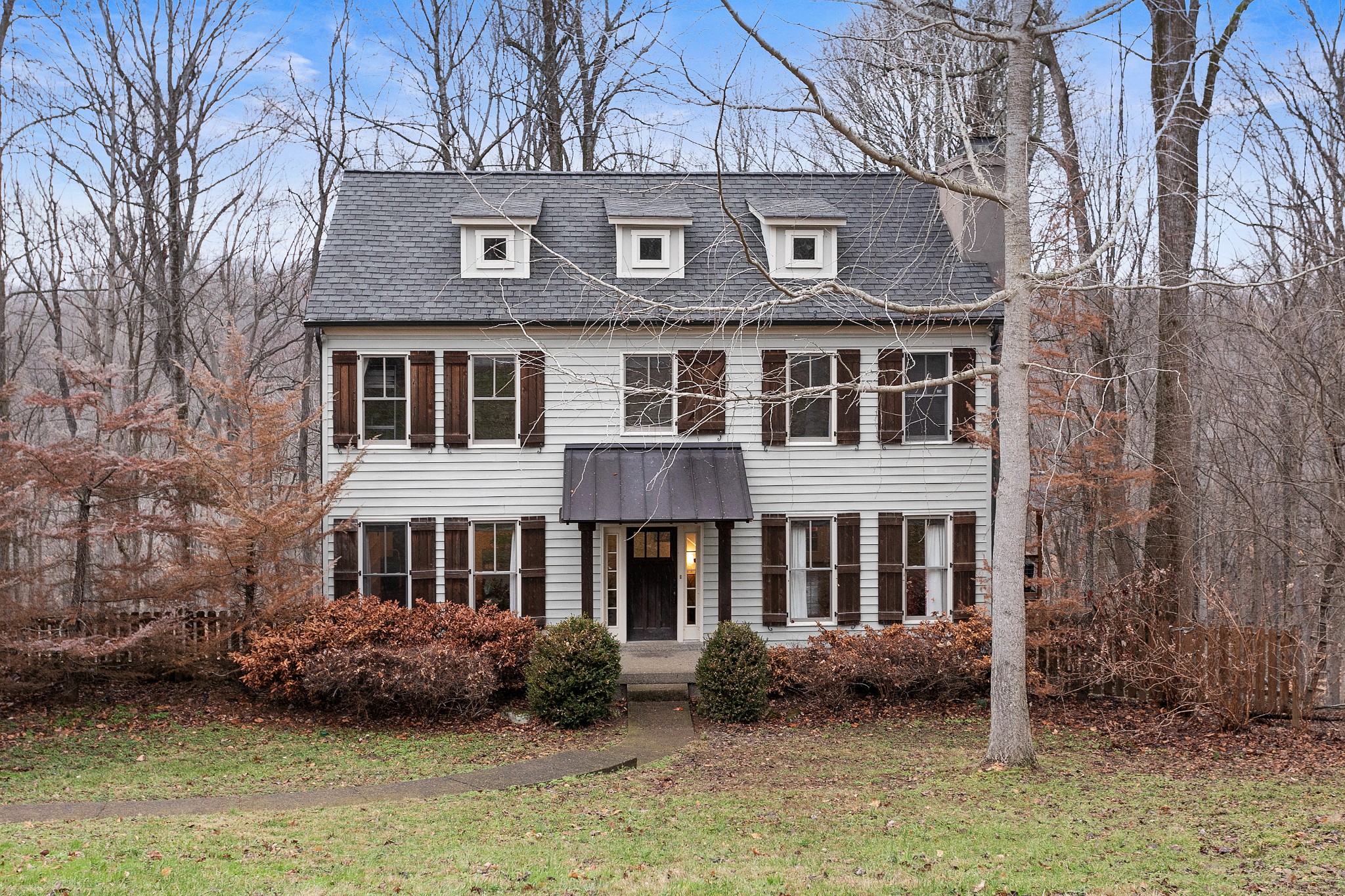 a front view of a house with garden