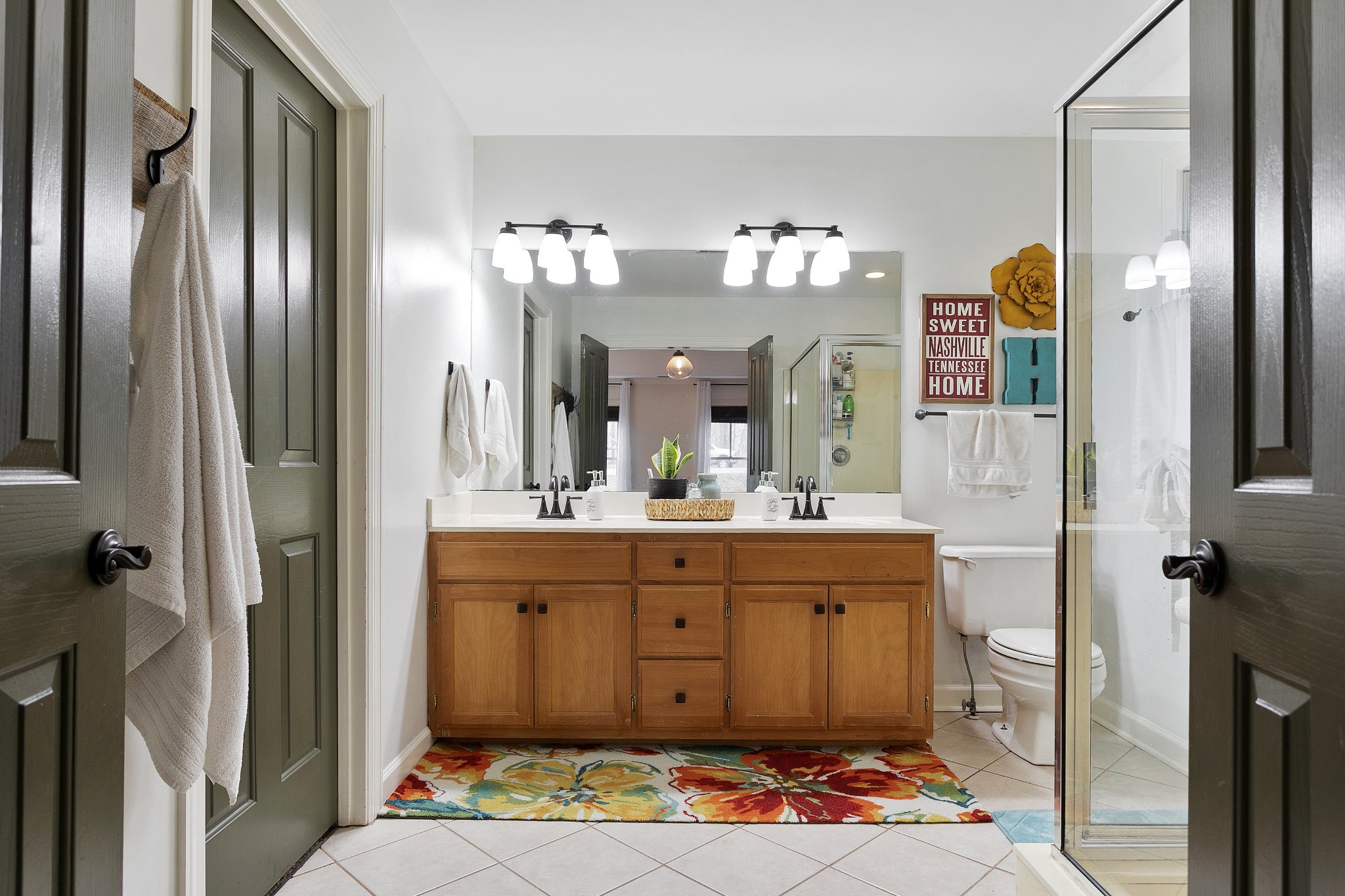 908 High Point Ridge Road Franklin, TN 37069 - Photo 35 of 69 a bathroom with a sink a mirror and a shower