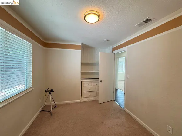 a view of an empty room with a window