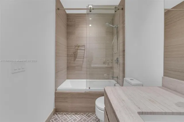 a bathroom with a toilet and a mirror