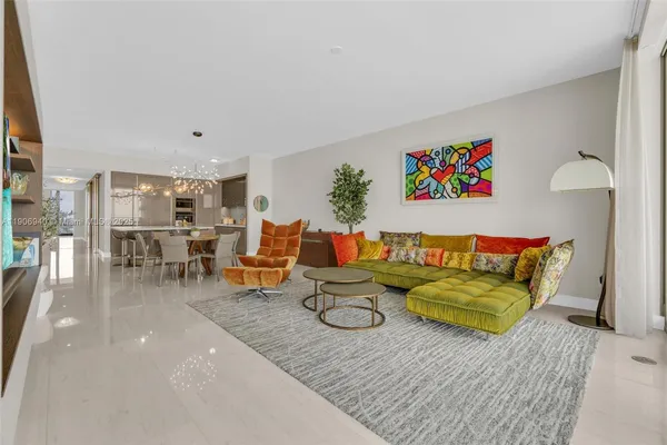 a living room with furniture and a floor to ceiling window
