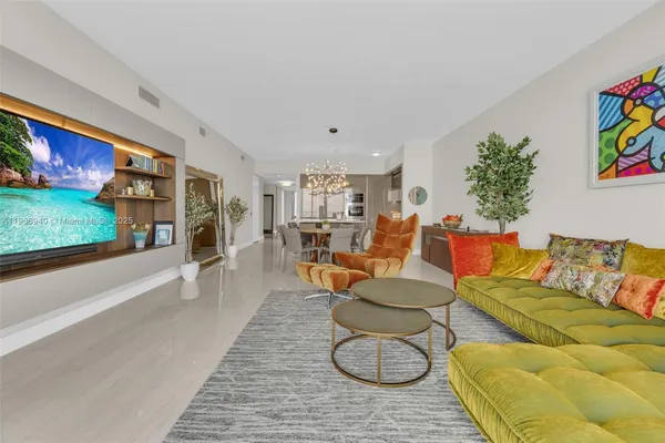 a living room with furniture a rug and a flat screen tv