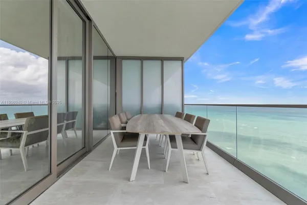 a balcony with chairs and a table