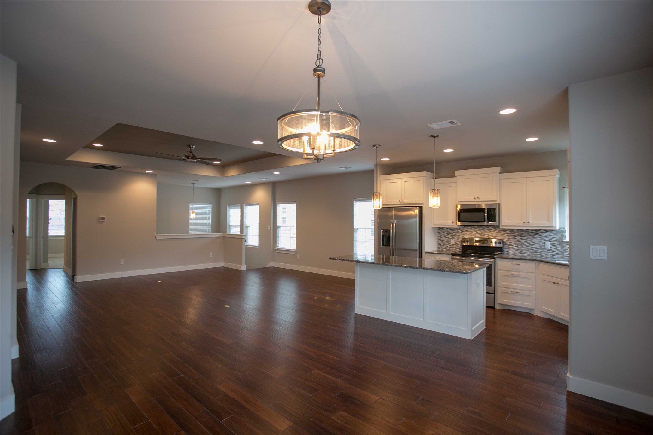 4301 Mansfield Dam Road, Unit 2102 Austin, TX 78734 - Photo 4 of 9 An open-concept living space integrates a well-appointed kitchen with rich hardwood flooring throughout.