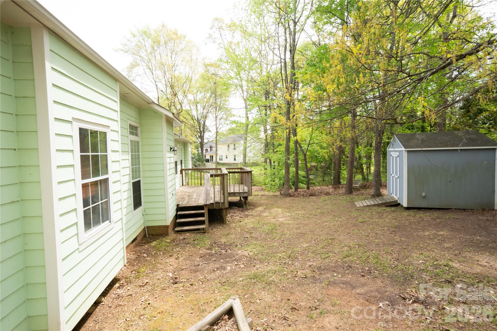 10737 Spruce Mountain Road Charlotte, NC 28214 - Photo 18 of 19 a view of a house with a backyard and chair