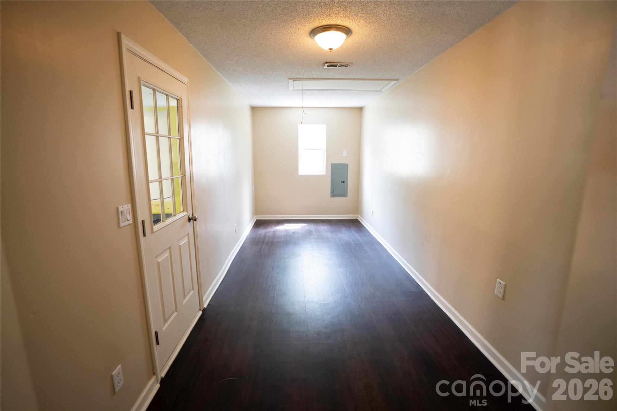 10737 Spruce Mountain Road Charlotte, NC 28214 - Photo 6 of 19 a view of a hallway with wooden floor and staircase
