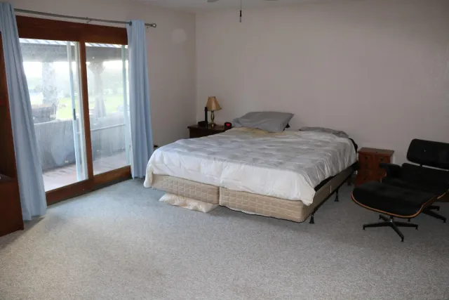 a bedroom with a bed and chair