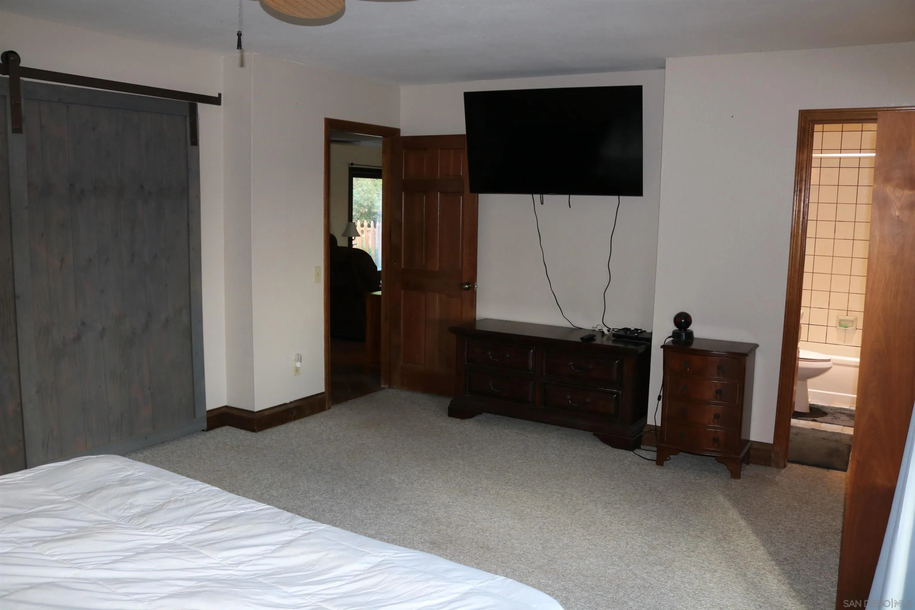 38083 De Luz Road Fallbrook, CA 92028 - Photo 14 of 29 a room with a bed and a flat screen tv