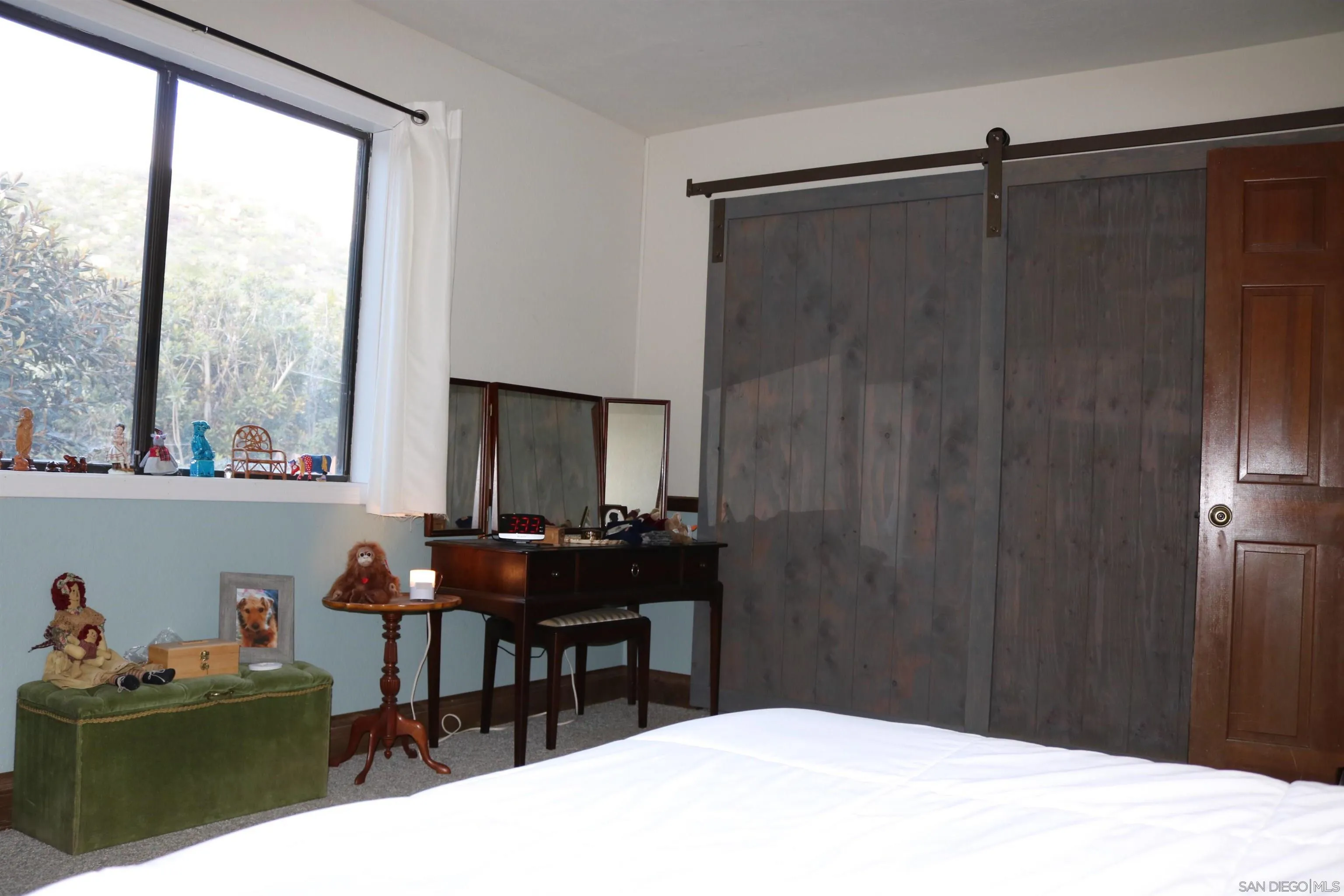 38083 De Luz Road Fallbrook, CA 92028 - Photo 17 of 29 a bedroom with a bed and a table