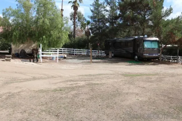 a view of house with outdoor space and parking