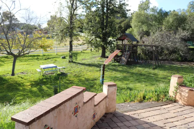 a view of a garden with plants and a lake view