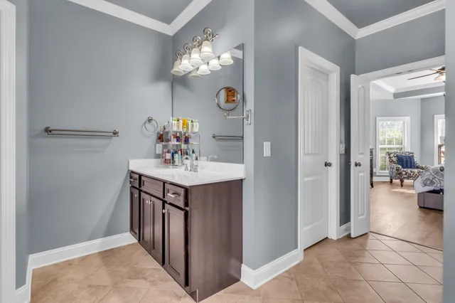 a spacious bathroom with a tub sink and mirror
