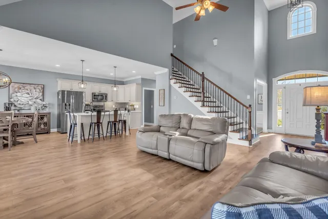 a living room with furniture a fireplace and a flat screen tv