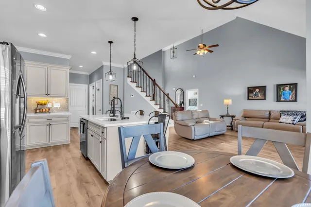 a kitchen with white cabinets and appliances