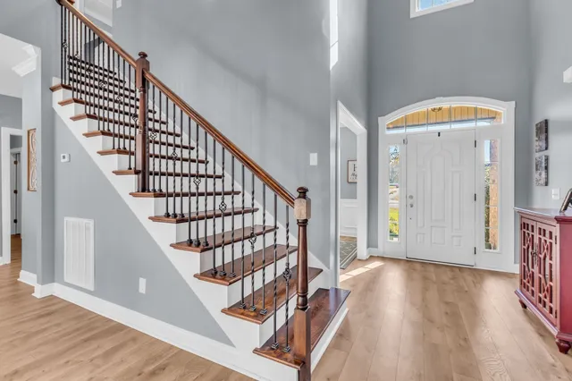 a view of a hallway with wooden floor and dining room view