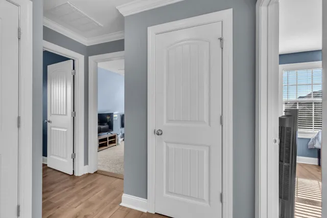a view of a hallway with a livingroom and a bathroom