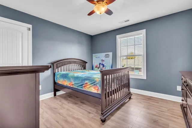 a bedroom with a bed and a potted plant