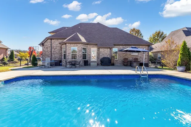 a view of a swimming pool with a table and chairs