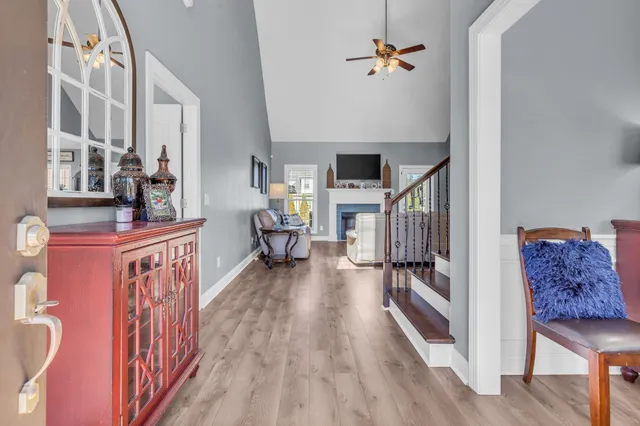 a view of a hallway with wooden floor and staircase