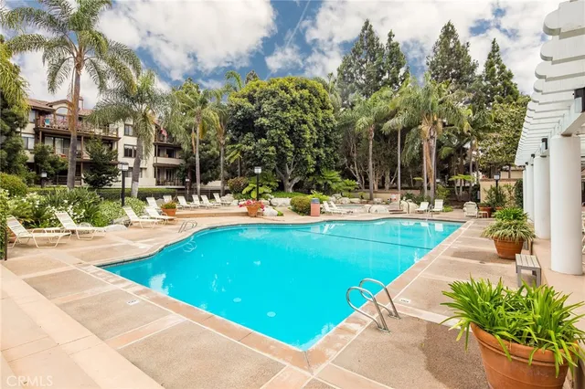 a swimming pool with outdoor seating and yard