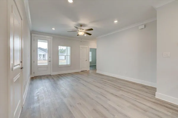 wooden floor in an empty room with a window