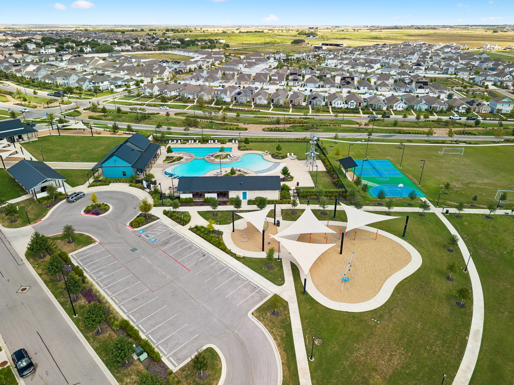 164 Appleberry Lane Elgin, TX 78621 - Photo 32 of 40 An expansive community amenity center features a sparkling pool, modern playground, and sports courts.