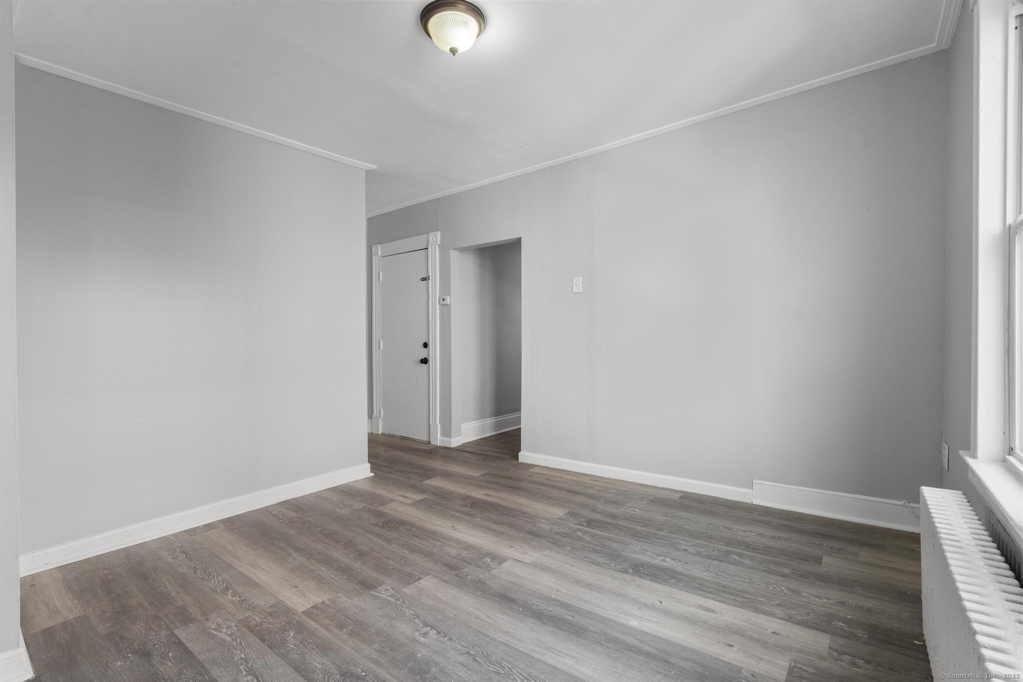 19 Whitmore Street Hartford, CT 06114 - Photo 11 of 27 a view of an empty room with wooden floor