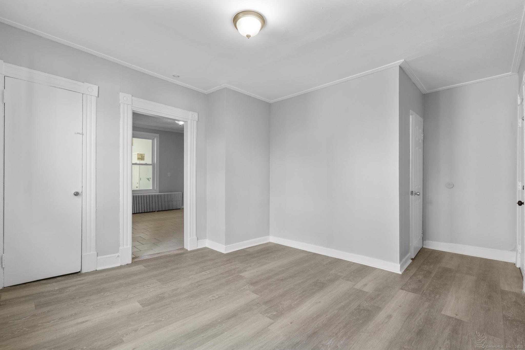 19 Whitmore Street Hartford, CT 06114 - Photo 12 of 27 a view of a room with wooden floor and white doors