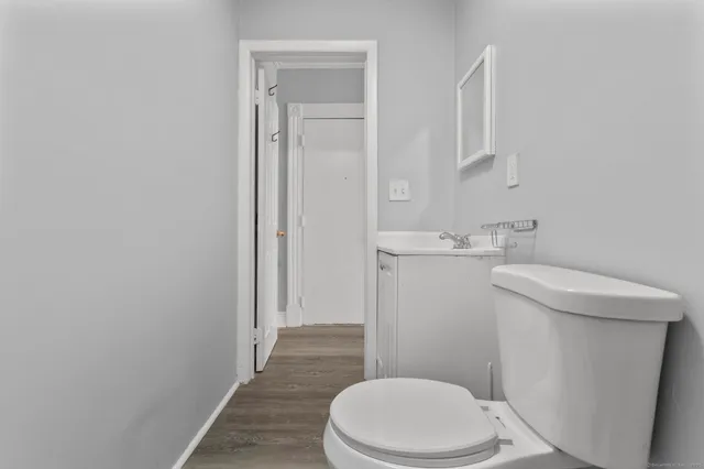 a white toilet sitting next to a bathroom sink