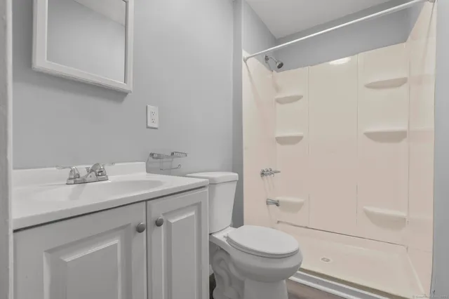 a bathroom with a sink toilet and shower