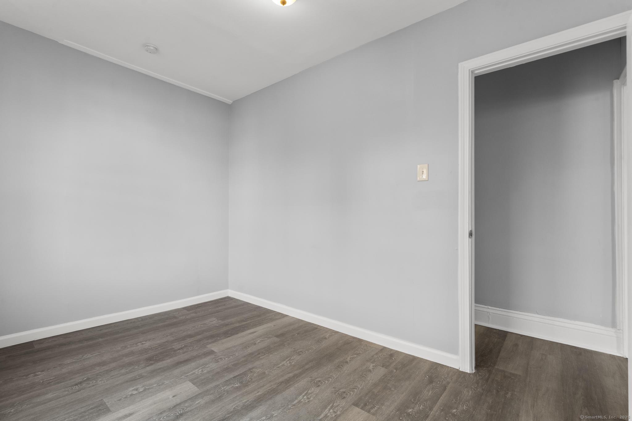 19 Whitmore Street Hartford, CT 06114 - Photo 16 of 27 a view of an empty room with wooden floor