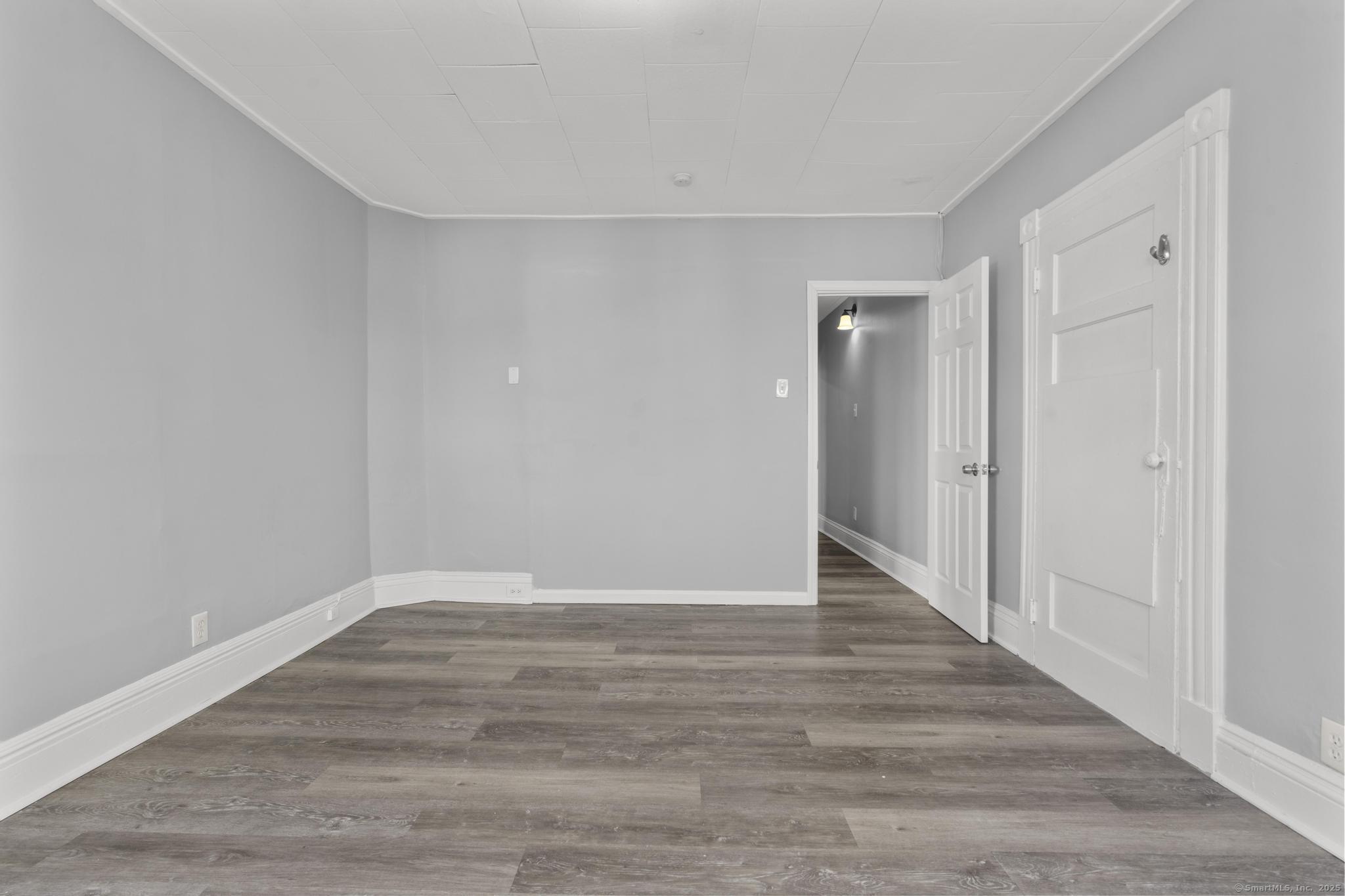 19 Whitmore Street Hartford, CT 06114 - Photo 19 of 27 a view of an empty room with wooden floor
